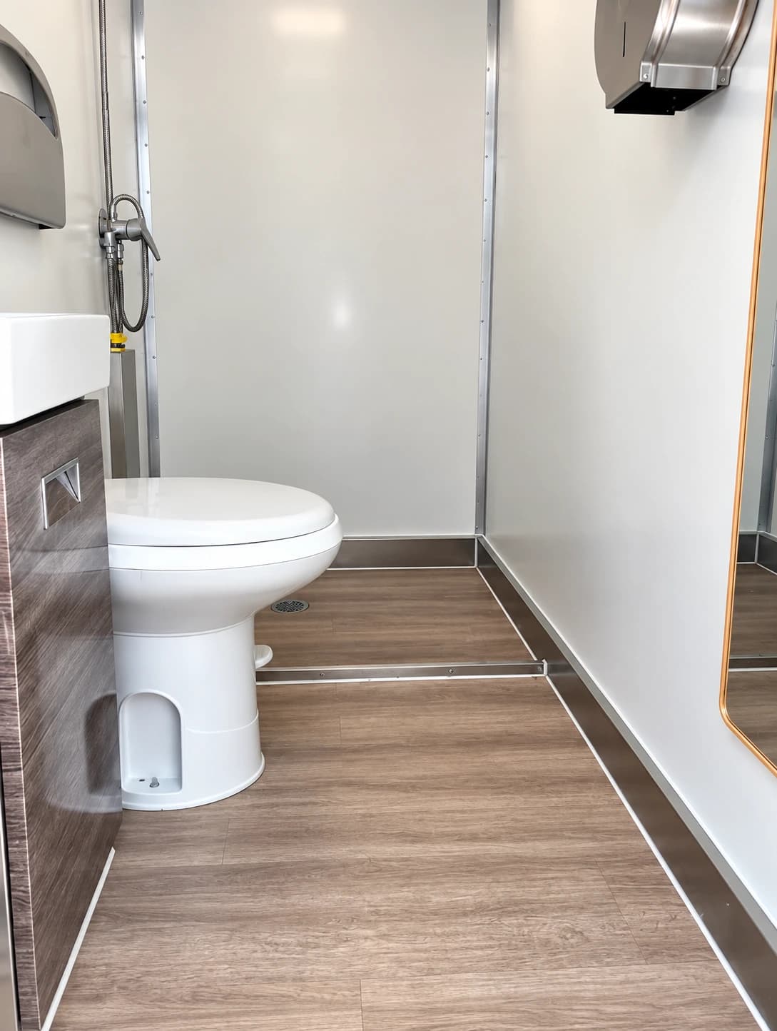 Shower and restroom combination trailer with a central passage