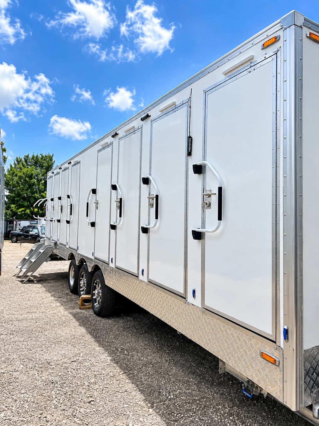 Shower and restroom trailer exterior with individual doors