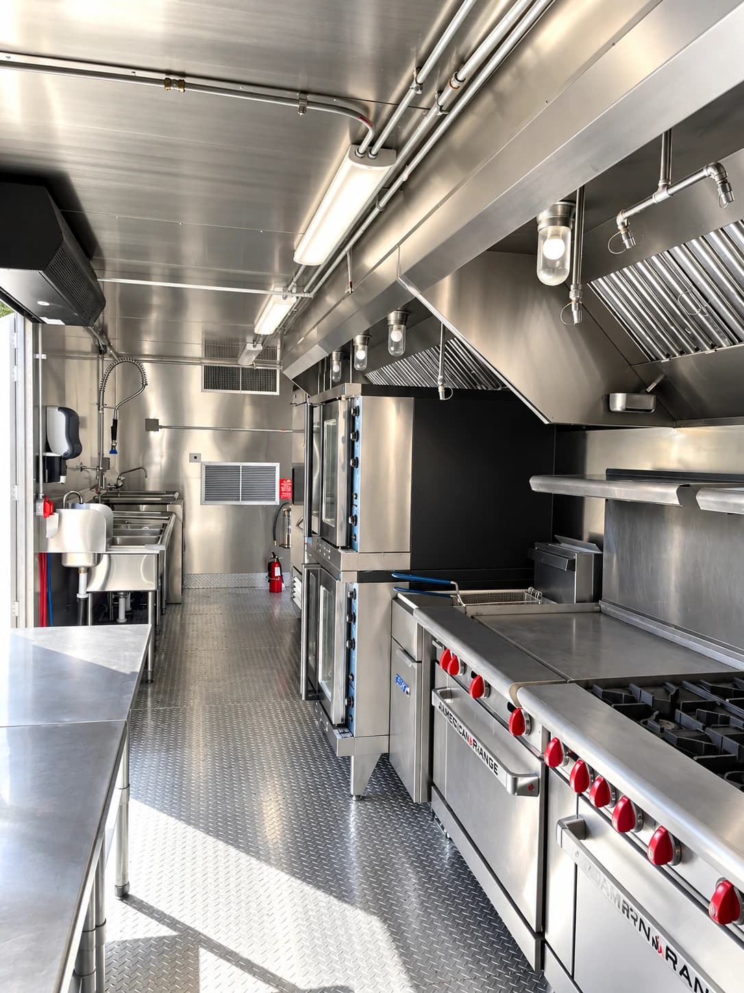 Commercial mobile kitchen with stainless steel cooking and preparation areas