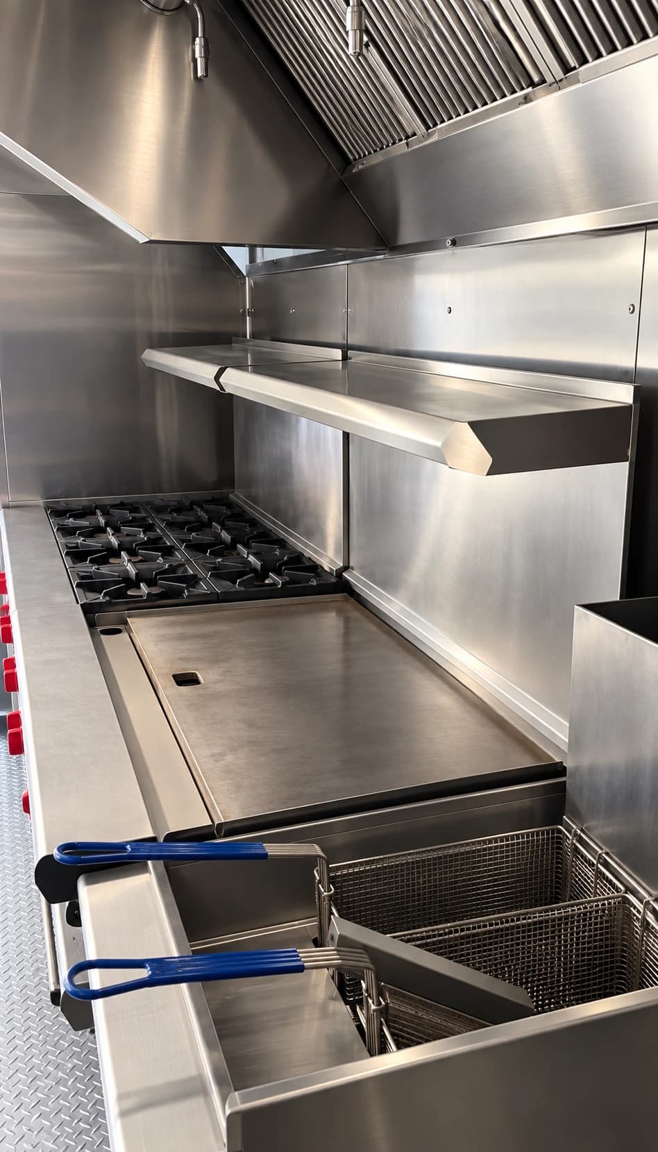 Commercial cooking equipment inside a kitchen trailer