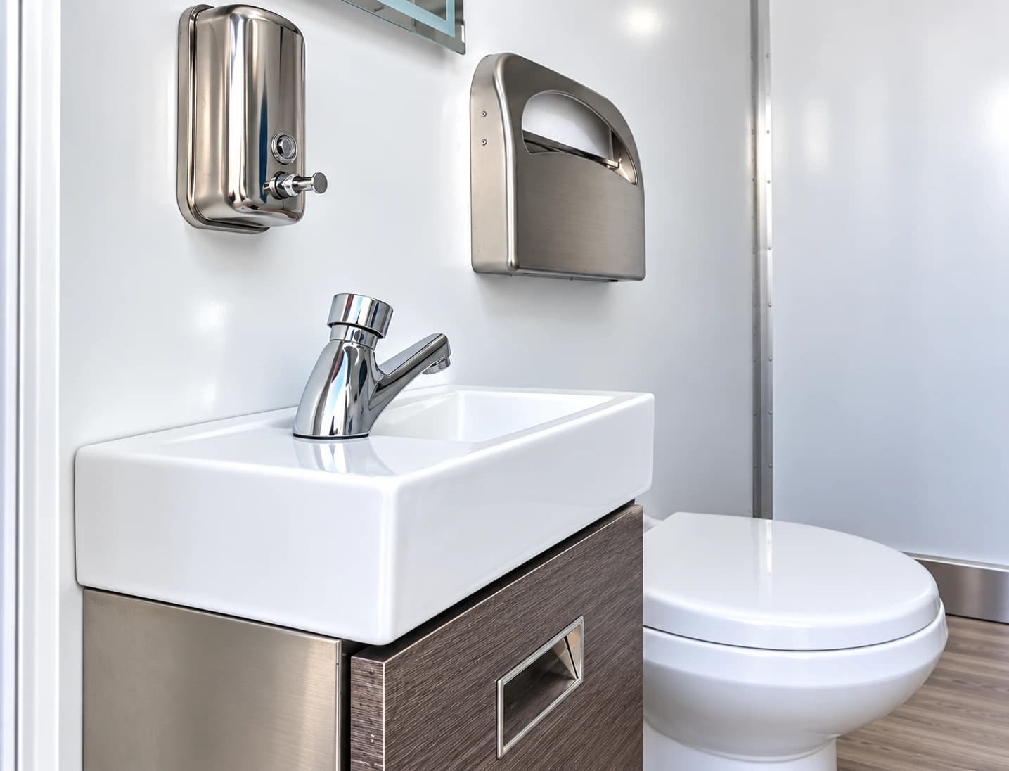 Sink and mirror in a portable restroom trailer