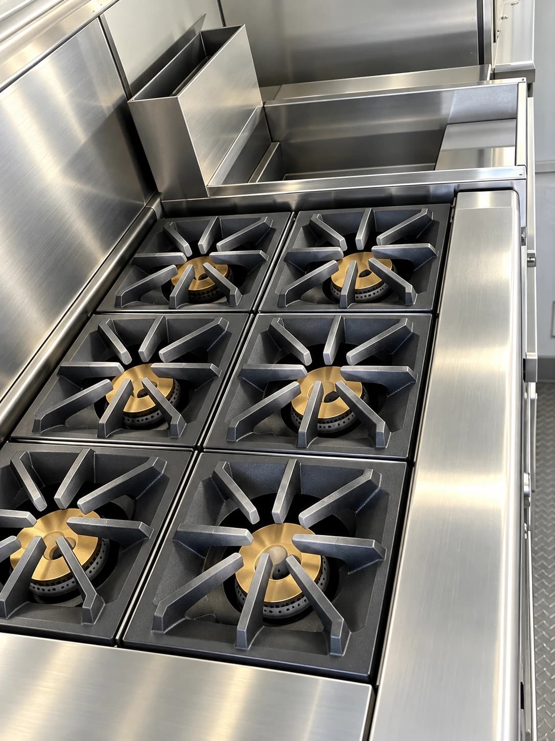 Six-burner commercial range inside a kitchen trailer