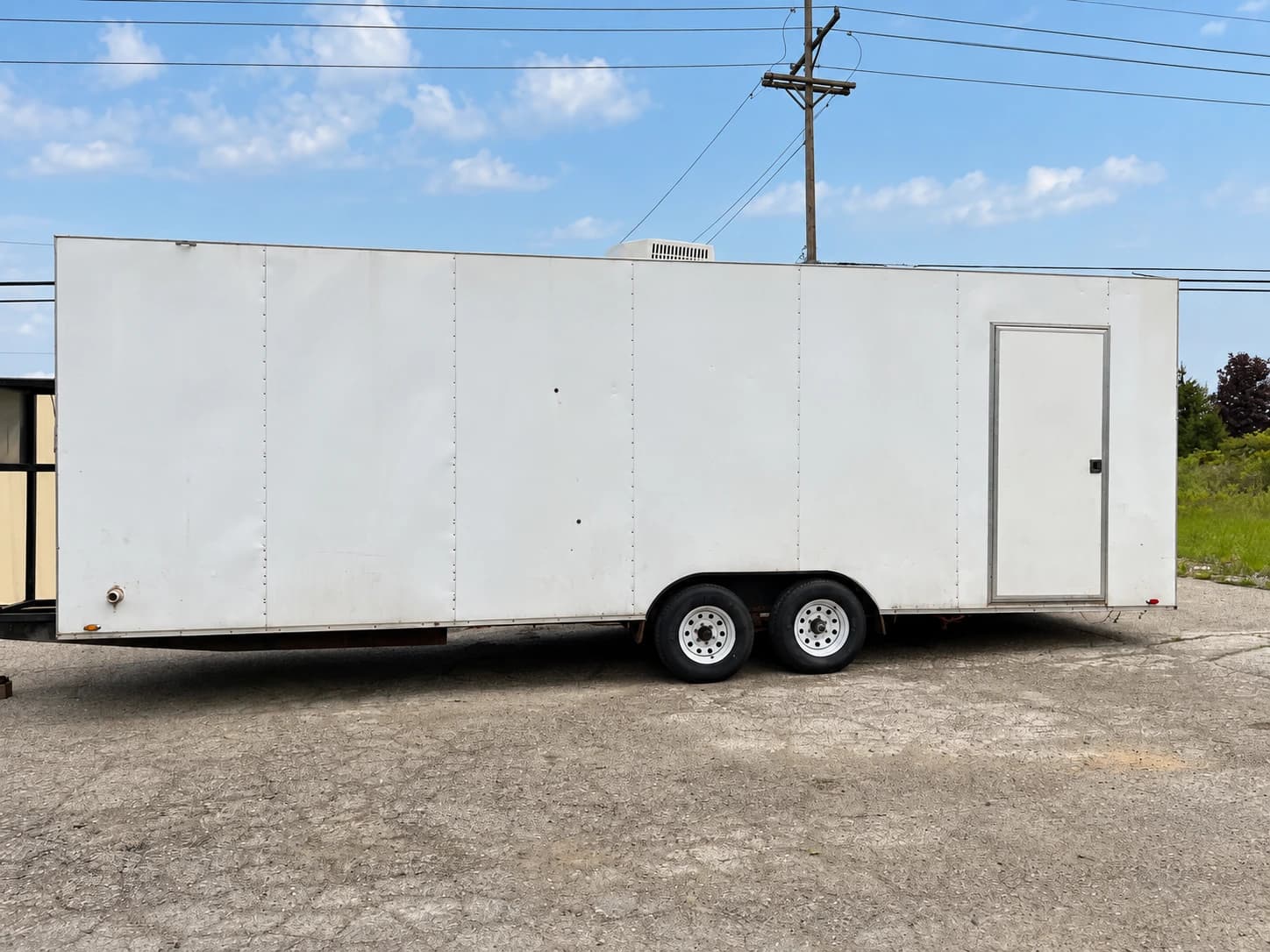 Commercial dishwashing trailer exterior with a personnel door