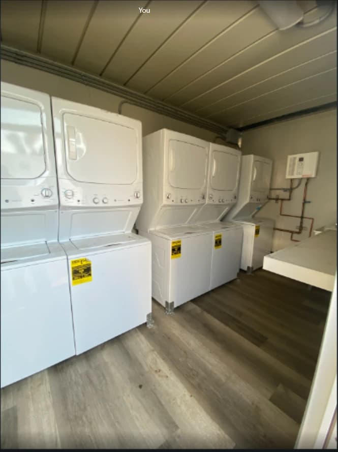 Laundry container interior with washing equipment and work access