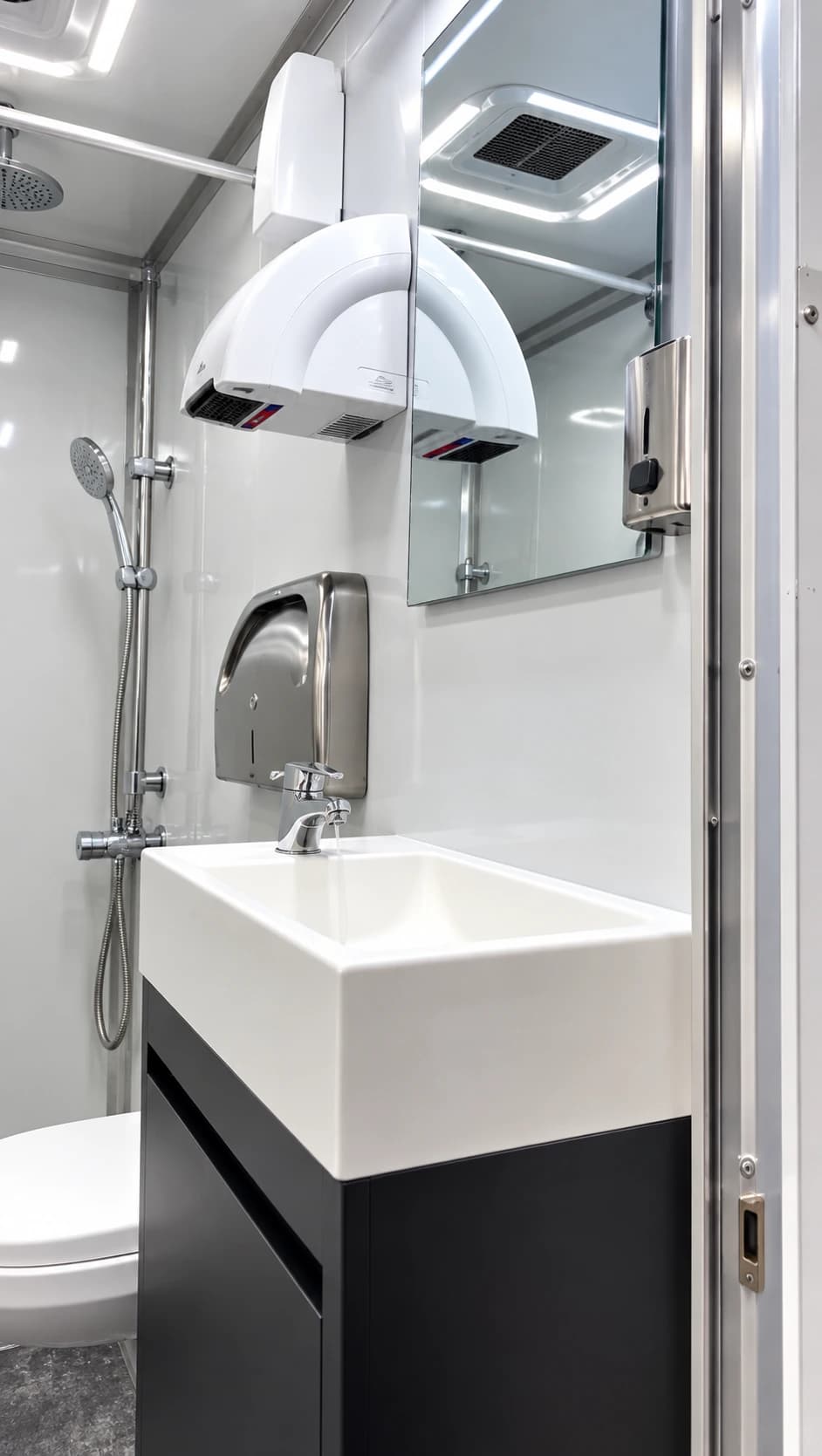 Sink and vanity inside a shower and restroom combination trailer
