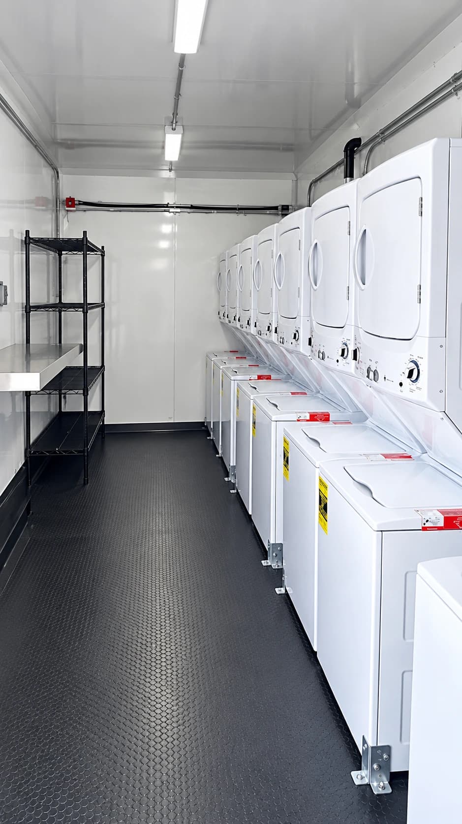 Commercial laundry trailer interior with washer and dryer stations