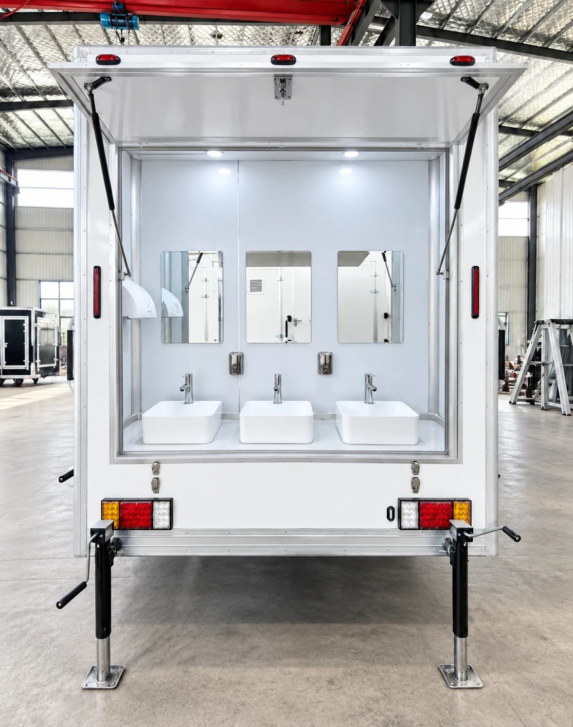 Shower stall with plumbing fixtures inside a portable unit